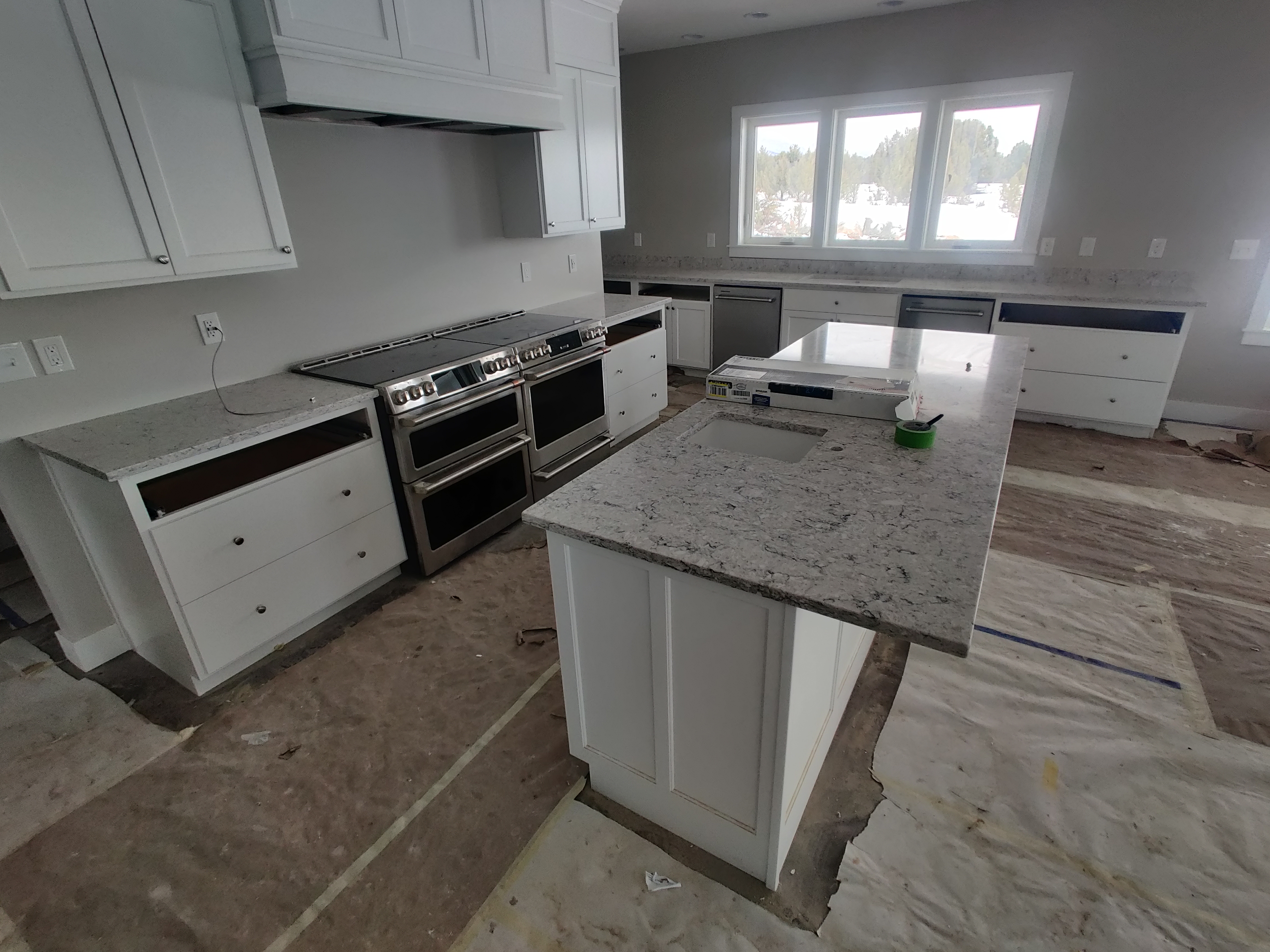 Kitchen under construction featuring dual ranges and expansive countertops